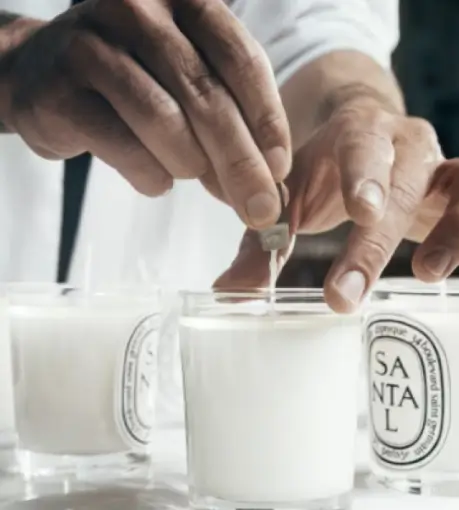 The wick of each candle is straightened by hand